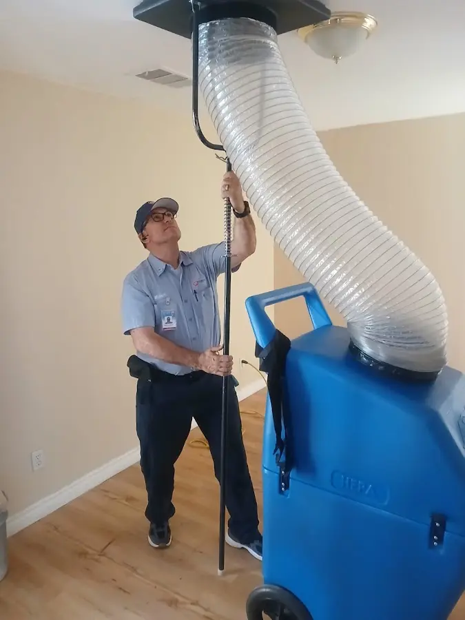 Furnace Tune-Up technician using HEPA equipment in Evansville